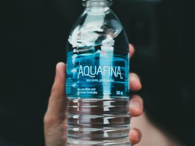 Close up of a person hands holding a water bottle.