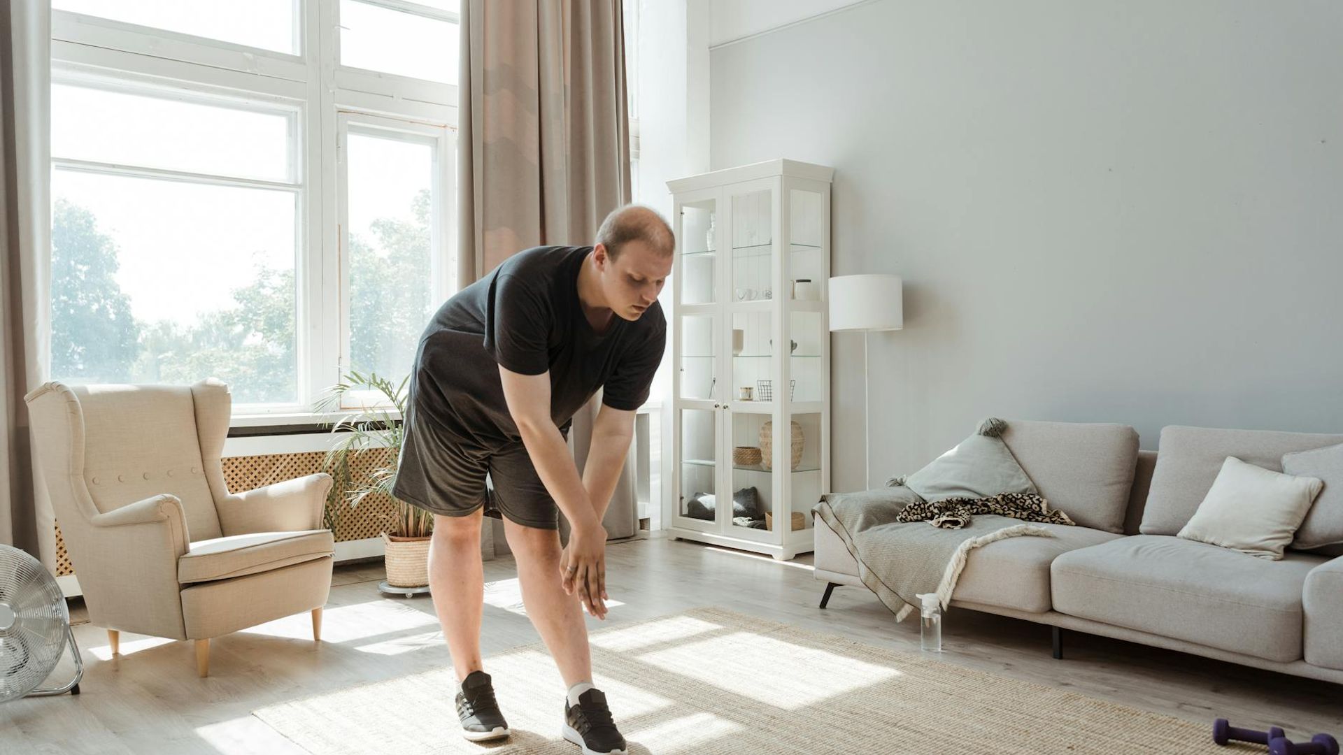 Person doing morning exercises in a bright minimalist room.